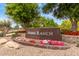 Landscaped community entrance sign with colorful flowers and mature trees at 1933 E Lafayette Ave, Gilbert, AZ 85298