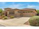 Attractive home featuring a well-maintained lawn, three-car garage, and desert landscaping at 1933 E Lafayette Ave, Gilbert, AZ 85298
