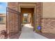 Inviting front entrance with decorative iron gate and stone accents at 1933 E Lafayette Ave, Gilbert, AZ 85298