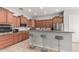 Well-lit kitchen features wooden cabinets, granite countertops, and stainless steel appliances at 1933 E Lafayette Ave, Gilbert, AZ 85298