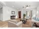 Bright living room with stylish furnishings, ceiling fan, and wood-look flooring, virtually staged for appeal at 1933 E Lafayette Ave, Gilbert, AZ 85298