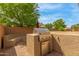 Backyard with built-in grill, seating area, and lush greenery, ideal for outdoor entertaining at 1933 E Lafayette Ave, Gilbert, AZ 85298