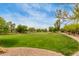 Expansive grassy park area surrounded by lush trees and paved walking paths at 1933 E Lafayette Ave, Gilbert, AZ 85298