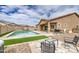 Beautiful backyard with a pool, seating, and well-kept landscaping at 19742 W Harrison St, Buckeye, AZ 85326