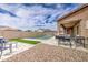 Backyard with pool, artificial grass, patio, and outdoor kitchen at 19742 W Harrison St, Buckeye, AZ 85326