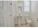 Bright half bathroom features a pedestal sink and a tile floor at 19742 W Harrison St, Buckeye, AZ 85326