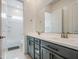 Bathroom featuring double sinks, modern cabinetry, and tub/shower combo at 19742 W Harrison St, Buckeye, AZ 85326