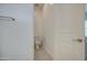 Bright half bath featuring a toilet and a closed door at 19742 W Harrison St, Buckeye, AZ 85326
