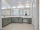 Large bathroom featuring dual sinks, gray cabinetry, and a walk-in shower at 19742 W Harrison St, Buckeye, AZ 85326