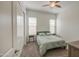 Bright bedroom features a ceiling fan, two large windows, and carpeted floor at 19742 W Harrison St, Buckeye, AZ 85326