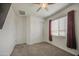 Bright bedroom with carpeted floors, ceiling fan, window, and closet at 19742 W Harrison St, Buckeye, AZ 85326