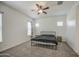 Simple bedroom design with natural light, ceiling fan, and neutral colors throughout at 19742 W Harrison St, Buckeye, AZ 85326