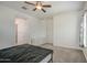 Spacious carpeted bedroom featuring a ceiling fan, and a white cabinet with drawers at 19742 W Harrison St, Buckeye, AZ 85326