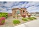 Lovely single-story home featuring stone detailing, a two-car garage, and vibrant landscaping at 19742 W Harrison St, Buckeye, AZ 85326
