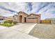 Charming single-Gathering home featuring a stone facade, two-car garage, and well-manicured landscaping at 19742 W Harrison St, Buckeye, AZ 85326