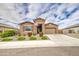 Attractive single-Gathering home with stone accents, a two-car garage, and manicured landscaping at 19742 W Harrison St, Buckeye, AZ 85326