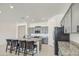 Spacious kitchen featuring gray cabinets, granite countertops, and a large island with bar seating at 19742 W Harrison St, Buckeye, AZ 85326