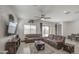 Inviting living room with plush sofas, ceiling fan, and view to the outdoor space at 19742 W Harrison St, Buckeye, AZ 85326