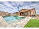 Backyard with a pool, artificial grass, and outdoor seating at 19742 W Harrison St, Buckeye, AZ 85326