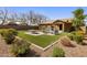 Spacious backyard featuring artificial turf, patio seating, and beautifully landscaped areas at 20181 N Lauren Rd, Maricopa, AZ 85138