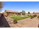 Large backyard with lush artificial turf, an outdoor seating area, and low-maintenance landscaping at 20181 N Lauren Rd, Maricopa, AZ 85138