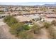 Aerial view of backyard featuring lush lawn, patio, spa, and desert landscaping, perfect for relaxation and entertaining at 20181 N Lauren Rd, Maricopa, AZ 85138