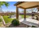 Inviting covered patio area with seating and a grill, perfect for outdoor entertaining and relaxation at 20181 N Lauren Rd, Maricopa, AZ 85138