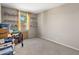 Cozy bedroom with neutral walls, gray carpet, a window, and shelving for storage at 20181 N Lauren Rd, Maricopa, AZ 85138
