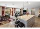 Open concept living and dining area with island, modern lighting, and patio access at 20181 N Lauren Rd, Maricopa, AZ 85138