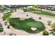 Beautiful aerial view of a home on the golf course surrounded by mature trees and lush landscaping at 21549 N Backus Dr, Maricopa, AZ 85138