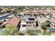 Aerial view of a home with solar panels, landscaped backyard, putting green, pool and view of neighborhood at 21549 N Backus Dr, Maricopa, AZ 85138