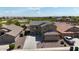 Stunning two-story home featuring a large driveway, well-manicured landscaping, and a beautiful desert golf course view at 21549 N Backus Dr, Maricopa, AZ 85138