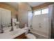 Well-maintained bathroom features a tub, shower combo, white vanity, and neutral finishes at 21549 N Backus Dr, Maricopa, AZ 85138