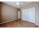 Spacious bedroom features closet doors and wood-look floors at 21549 N Backus Dr, Maricopa, AZ 85138