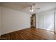 Spacious bedroom with hardwood floors, ceiling fan, and closet for ample storage at 21549 N Backus Dr, Maricopa, AZ 85138
