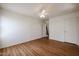 This empty bedroom has hardwood floors, neutral paint, and a ceiling fan at 21549 N Backus Dr, Maricopa, AZ 85138