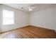 Bright bedroom features modern ceiling fan, large window and wood-look floors at 21549 N Backus Dr, Maricopa, AZ 85138