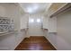 Walk-in closet with custom shelving and wood-look floors at 21549 N Backus Dr, Maricopa, AZ 85138