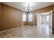 Cozy dining room with tile flooring, chandelier, and a view of the kitchen at 21549 N Backus Dr, Maricopa, AZ 85138
