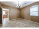Dining room features neutral paint, tile floors, and chandelier lighting at 21549 N Backus Dr, Maricopa, AZ 85138