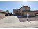 Charming two-story home boasts a spacious driveway, attached garage, and low-maintenance desert landscaping at 21549 N Backus Dr, Maricopa, AZ 85138