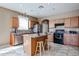 Charming kitchen features granite countertops, a center island with seating, and stainless steel appliances at 21549 N Backus Dr, Maricopa, AZ 85138