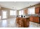 Bright kitchen with a center island, breakfast bar seating, and ample counter space at 21549 N Backus Dr, Maricopa, AZ 85138