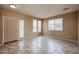 Inviting living room featuring tile floors, neutral paint, and multiple windows providing natural light at 21549 N Backus Dr, Maricopa, AZ 85138