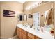 Bright bathroom featuring a double vanity, large mirror, and ample counter space at 21963 W Tonto St, Buckeye, AZ 85326