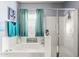 Relaxing bathroom featuring a soaking tub, a glass-enclosed shower, and calming blue accents at 21963 W Tonto St, Buckeye, AZ 85326