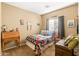 Charming bedroom featuring a cozy quilt bed, vintage decor, and natural light at 21963 W Tonto St, Buckeye, AZ 85326