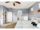 Comfortable bedroom with blue accent wall and plush carpeting, flowing through to a tranquil bathroom at 21963 W Tonto St, Buckeye, AZ 85326
