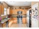 Functional kitchen featuring stainless steel appliances, light wood cabinets, and a tile floor at 21963 W Tonto St, Buckeye, AZ 85326