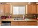 Practical kitchen design with wooden cabinets, granite countertops, and modern appliances at 21963 W Tonto St, Buckeye, AZ 85326